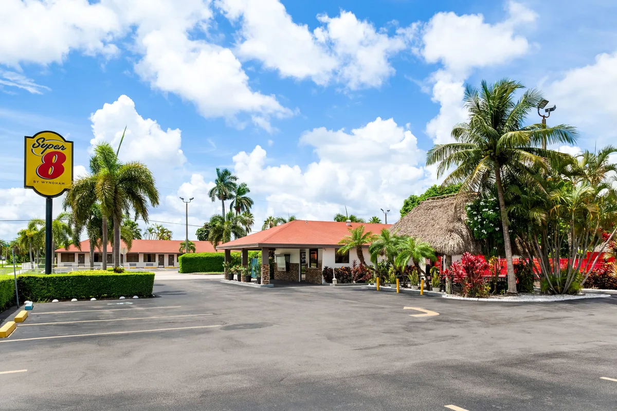 Super 8 by Wyndham Florida City exterior with palm trees